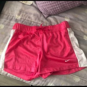 Hot pink Nike mesh shorts.
